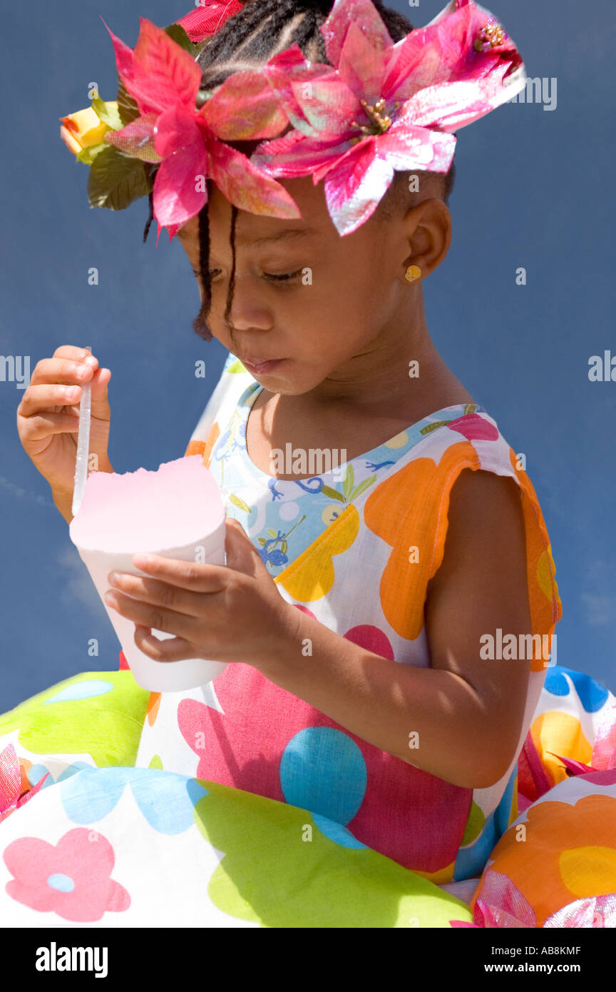 WEST INDIES TRINIDAD PORT OF SPAIN CARNIVAL 2006 Little girl enjoying a snow cone at the Kiddies Carnival Stock Photo