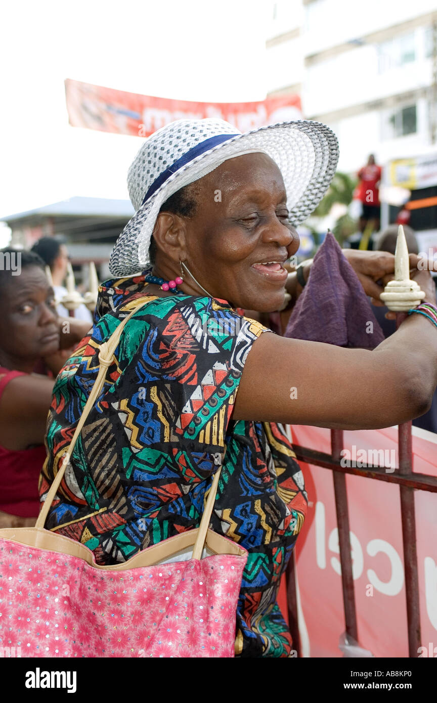 West Indies Trinidad Carnival Port of Spain Woman wearing straw watching Kiddies parade. Stock Photo