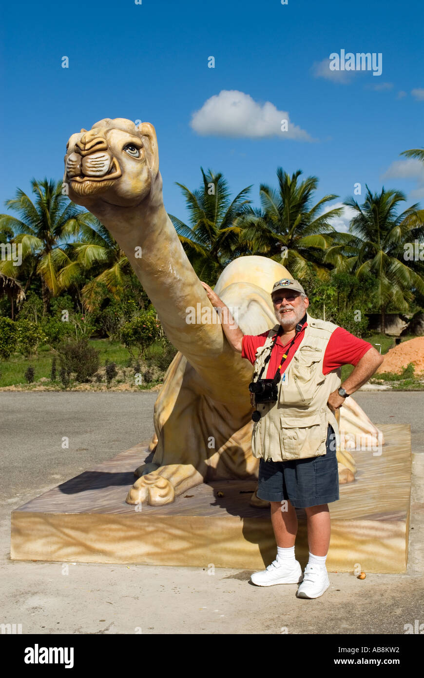 Caribbean West Indies Trinidad Carapichaima Sri Hanuman Murti Hindu Site Mature Male Tourist posing next to Camel Stock Photo
