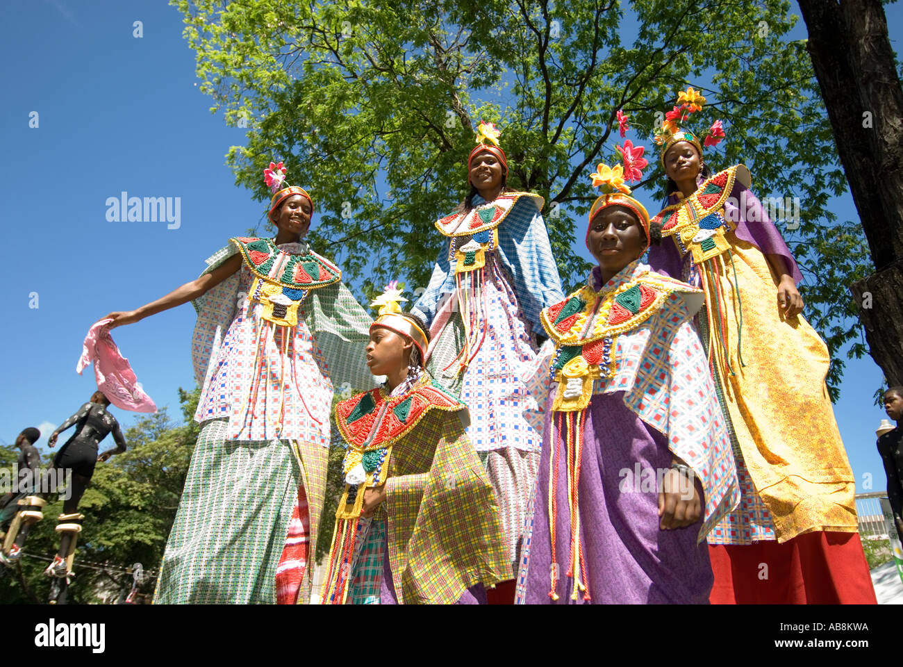West Indies Trinidad Carnival Port of Spain Teenagers on stilts wearing colorful costumes Kiddies carnival parade. Stock Photo
