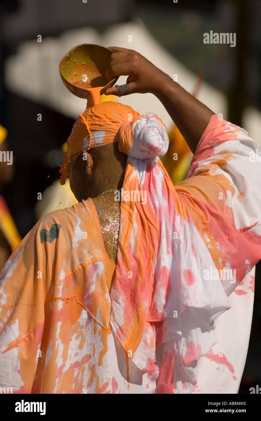 West Indies Port of Spain Trinidad Tobago Carnival 2006 Portrait of man pouring orange paint over his head main stage. Stock Photo