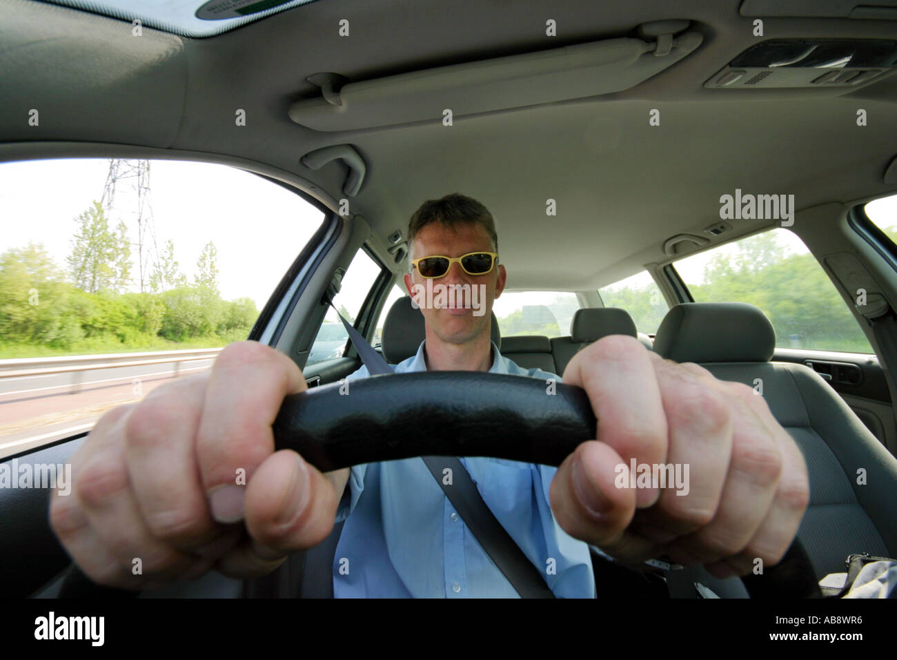 Man wearing sunglasses driving car hires stock photography and images