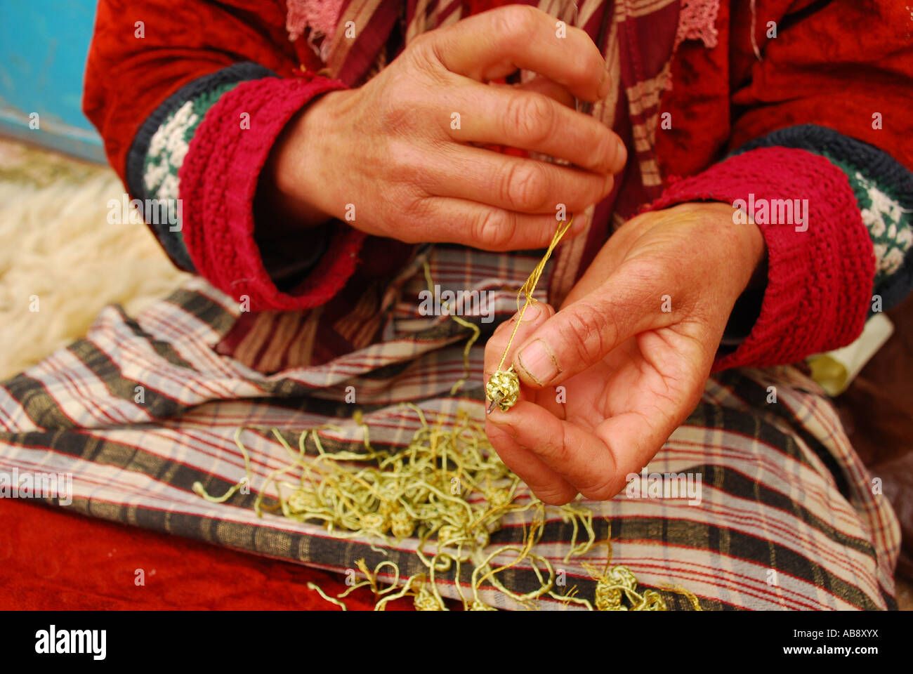Peasant women making buttons for Djellaba Bhalil Morocco Stock Photo
