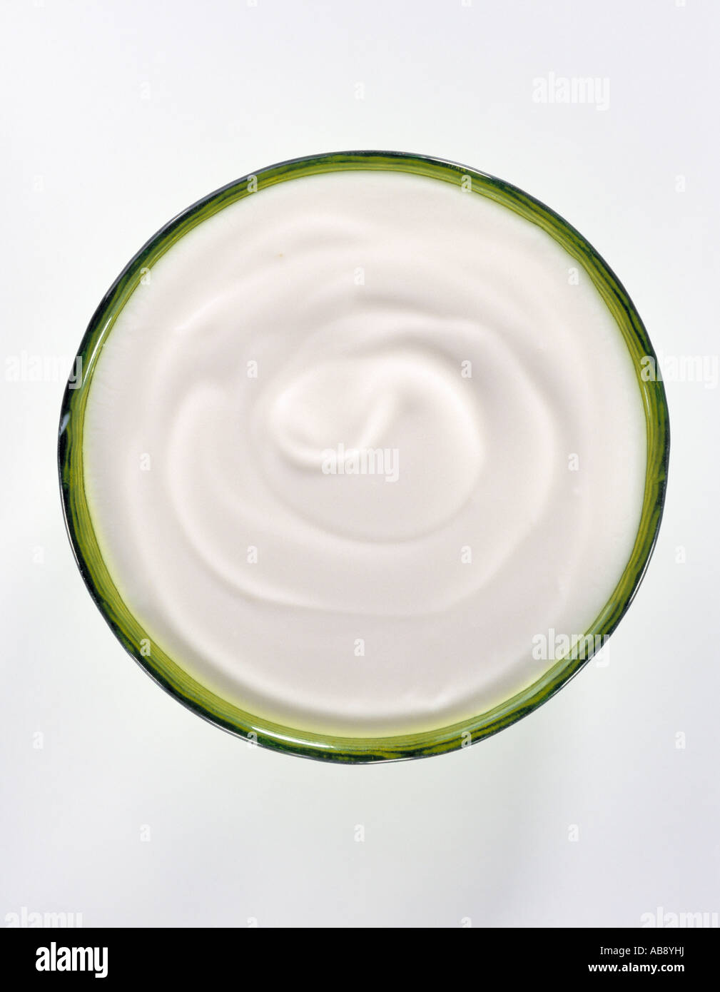 A pot of natural yogurt shot overhead on a white background Stock Photo