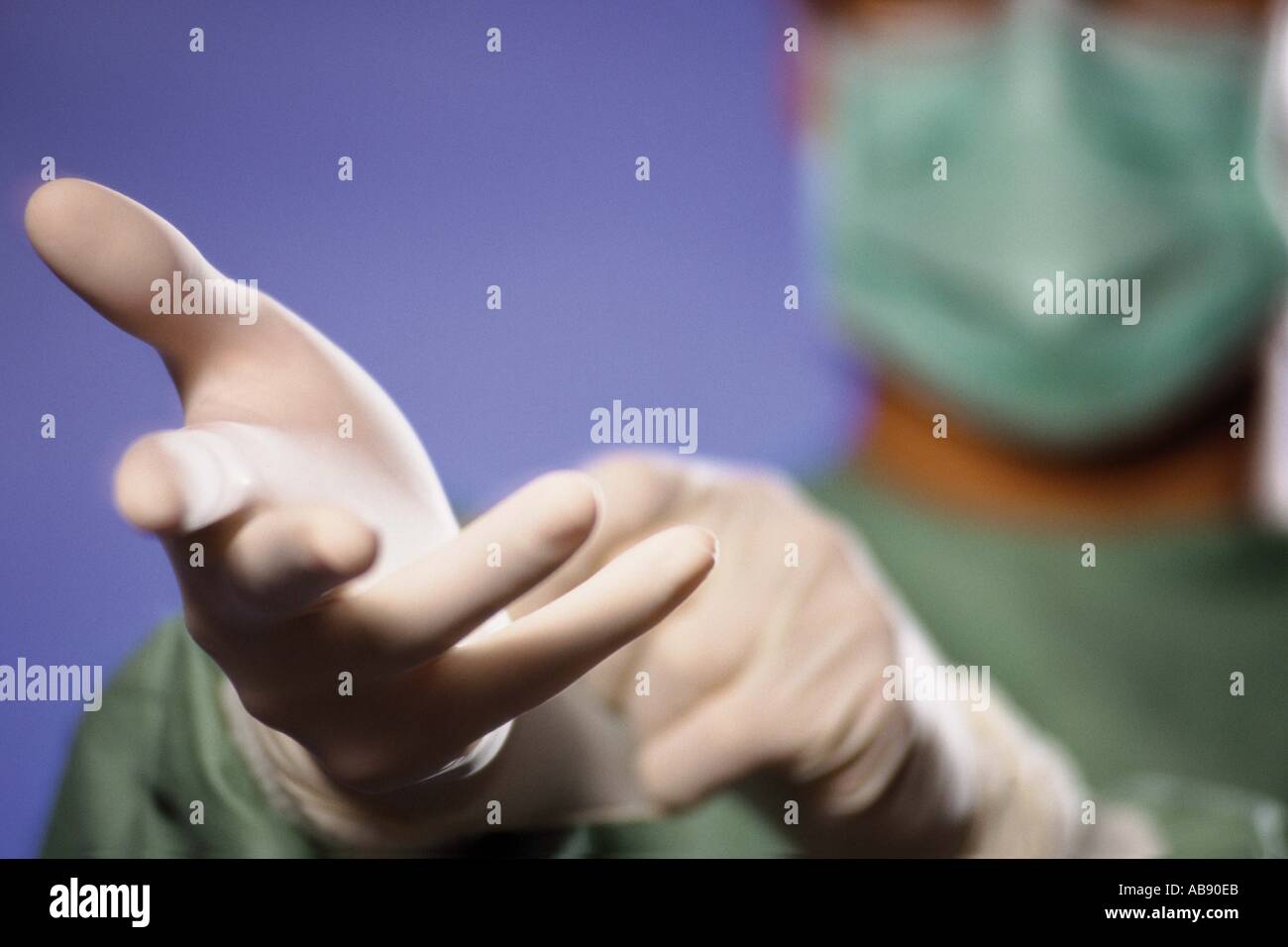 Surgeon putting on gloves Stock Photo
