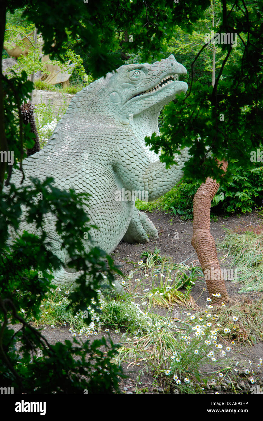 Hylaeosaurus dinosaur statue seen through the trees in Crystal Palace