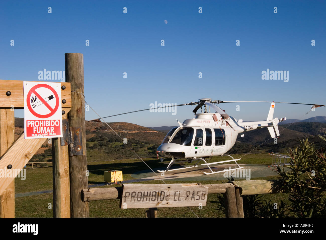 A Mountain Rescue Helicopter waits on it s Helipad in Parque Natural De Monfrague Extremadura Spain Stock Photo