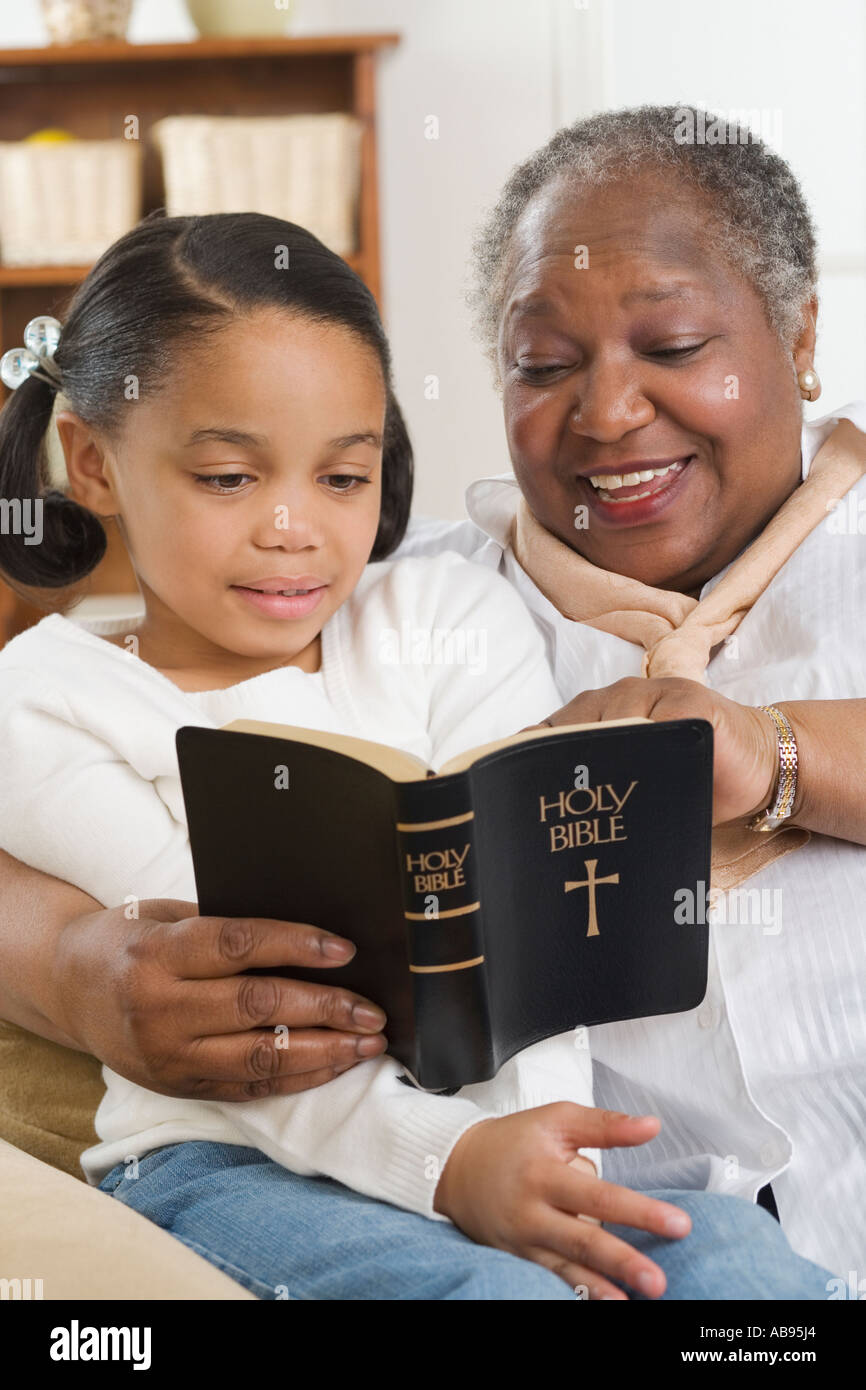 Senior woman reading the Bible to her granddaughter Stock Photo - Alamy