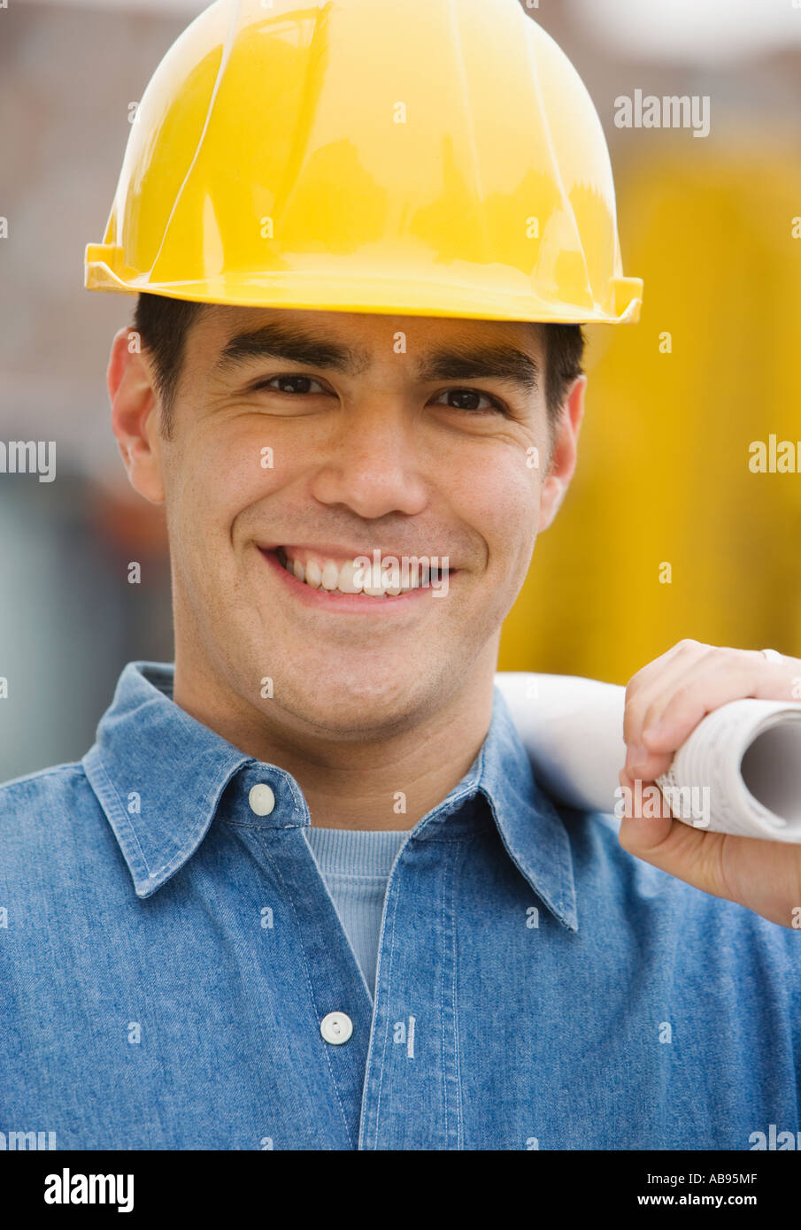 Manual worker holding blueprints Stock Photo