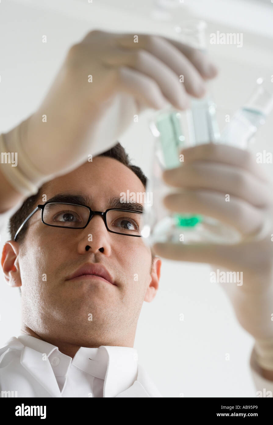 Scientist examining chemicals in test tubes Stock Photo Alamy