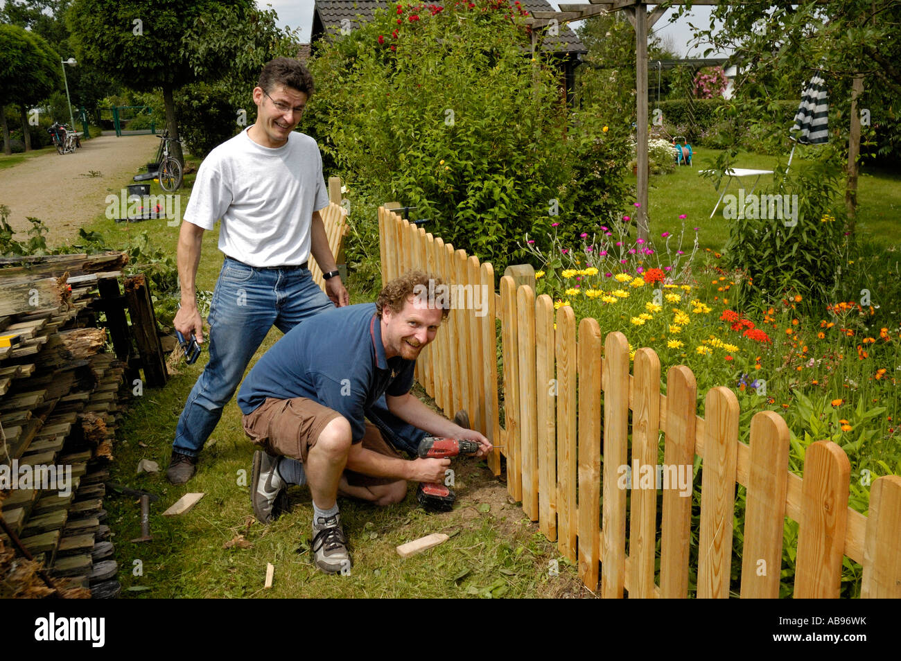 Handymen building a garden fence on allotments in Germany Stock Photo