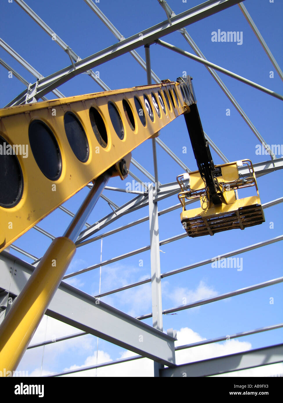Steel portal frame building during construction with access hoist Stock