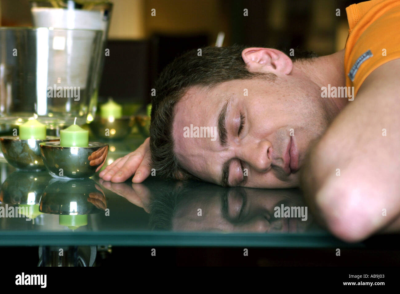 man sleeping on living room table. Stock Photo