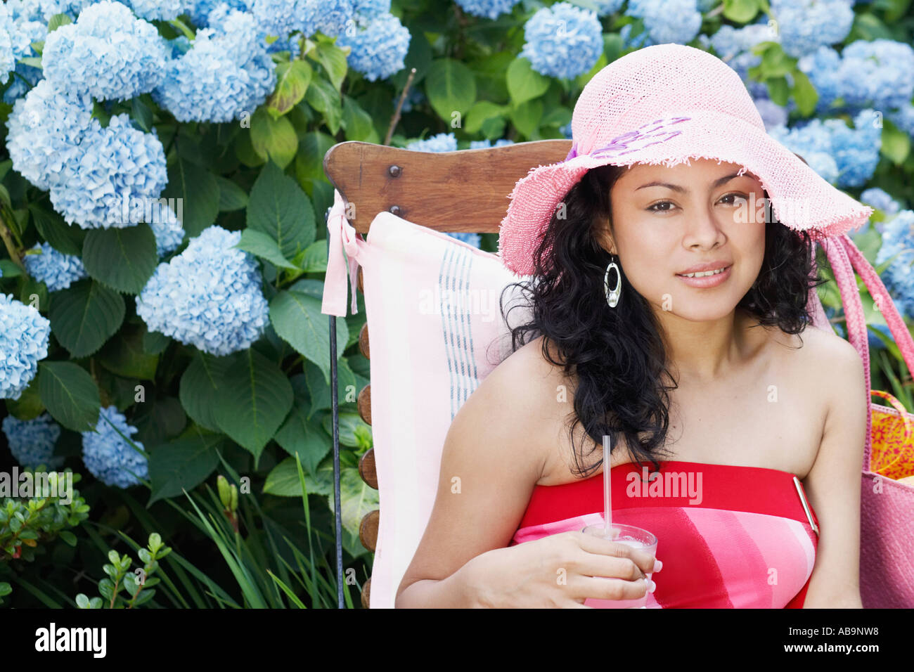 Young woman relaxing in a lawn chair Stock Photo - Alamy