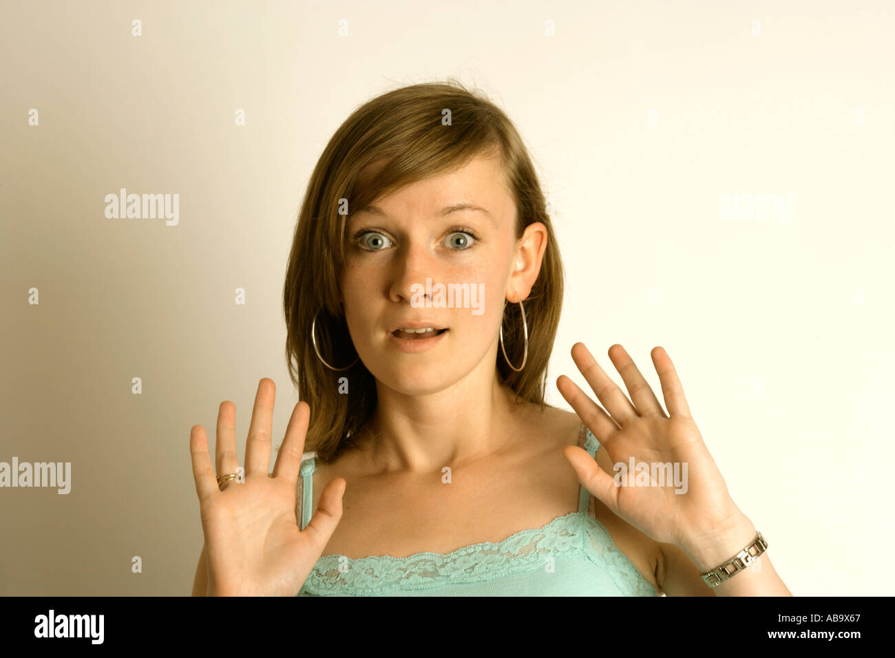 surprised or shocked expression on a young woman s face Stock Photo