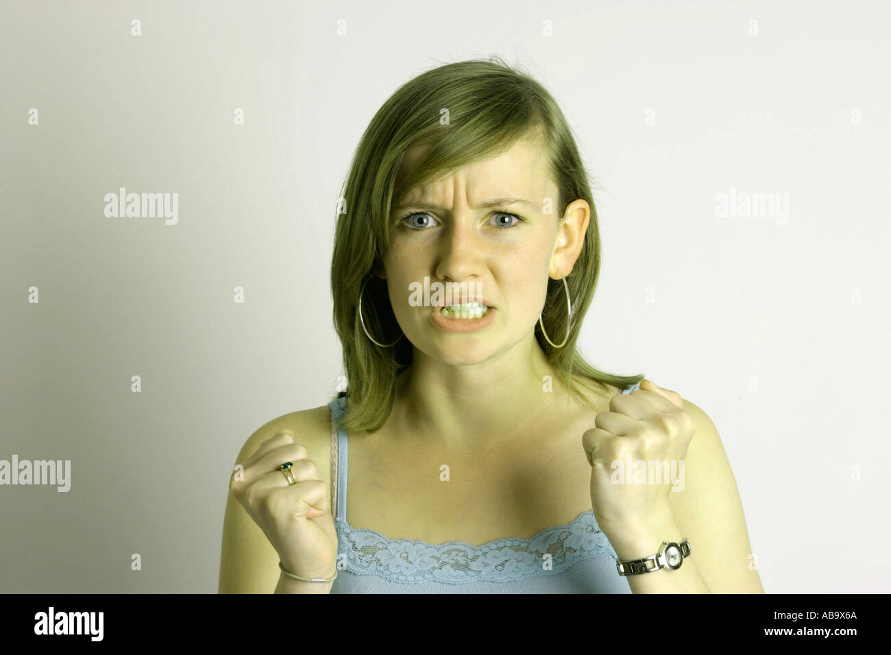 Angst anger frustration stress annoyance  Expressions of a young woman green with  envy envious Stock Photo
