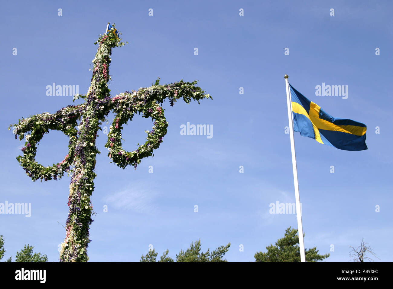 Traditional mid summer pole and Swedish flag Stock Photo