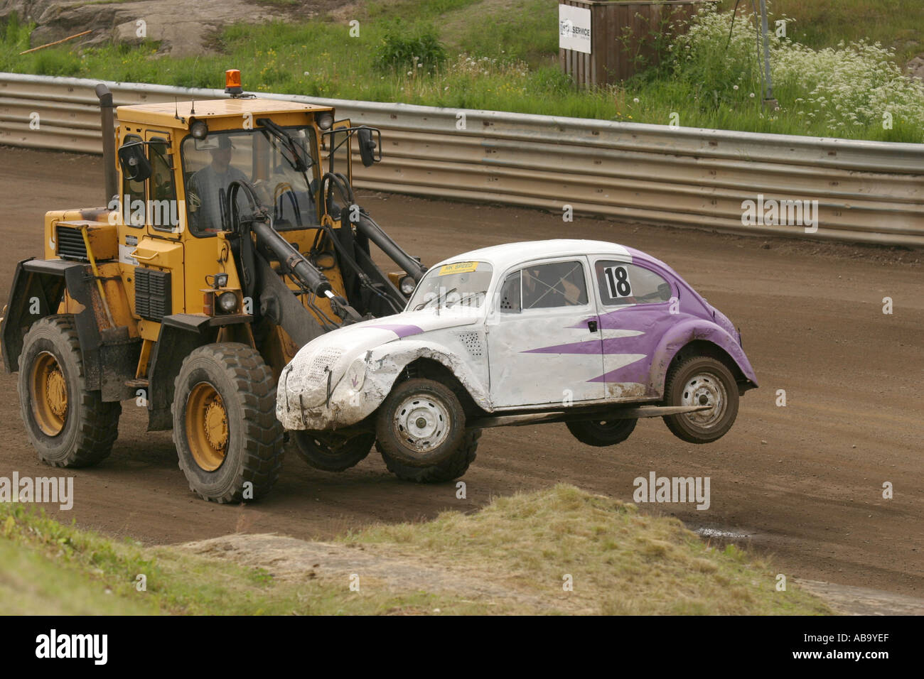 A Forklift Truck Is Carrying Away A Broken Car At A Stock Car Race Stock Photo Alamy