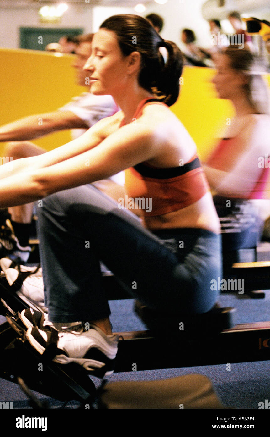 Woman on rowing machine Stock Photo