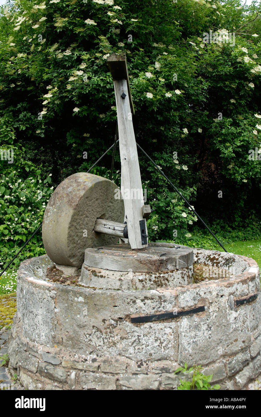 An old apple press in Hereford. These presses were used in the making of cider, it now is used as decoration. Stock Photo