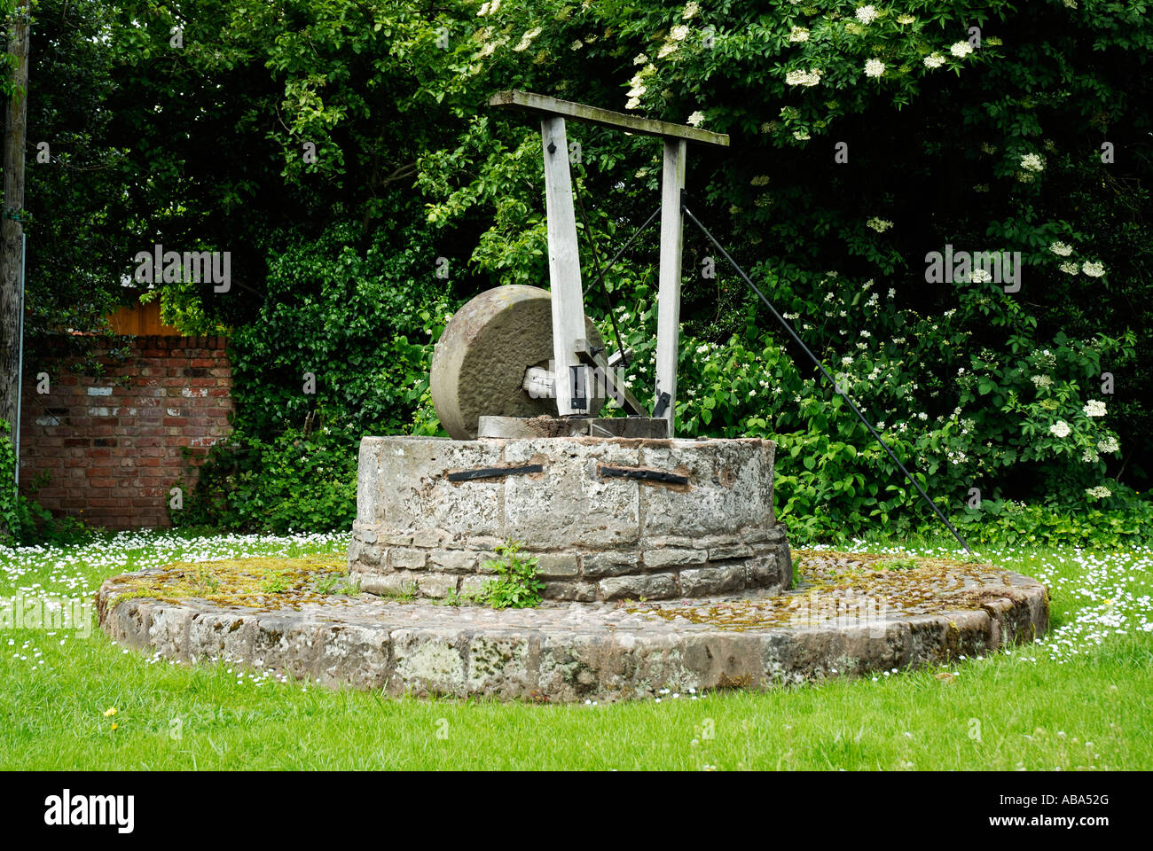 An old apple press in Hereford. These presses were used in the making of cider, it now is used as decoration. Stock Photo