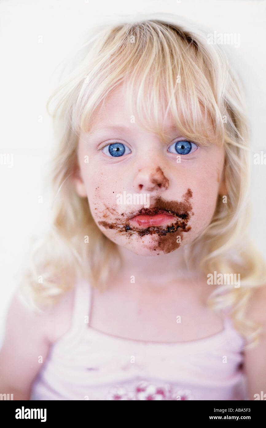 Girl with chocolate on her face Stock Photo