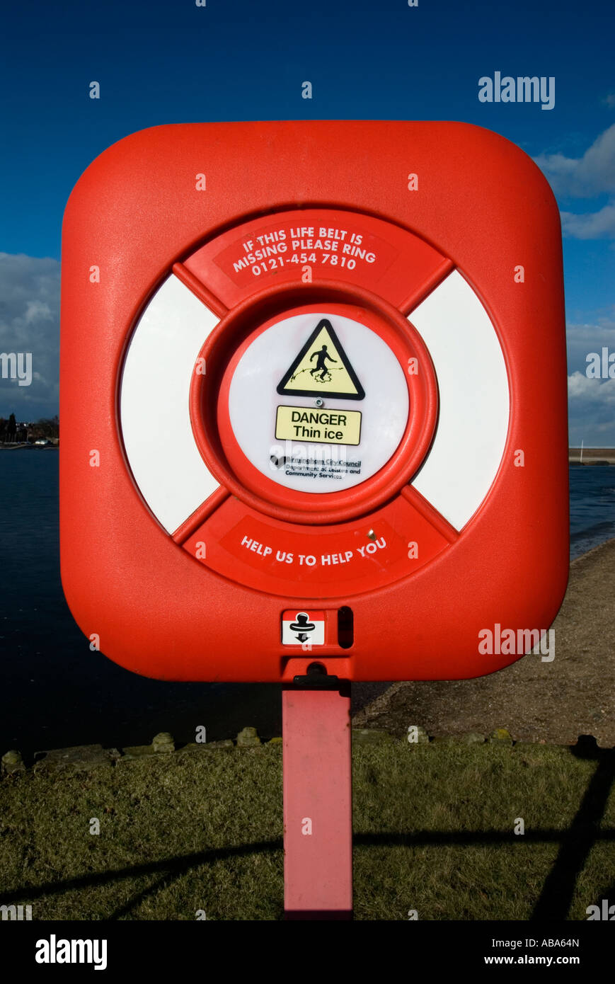 a life saving ring next to a reservoir used to throw to people in