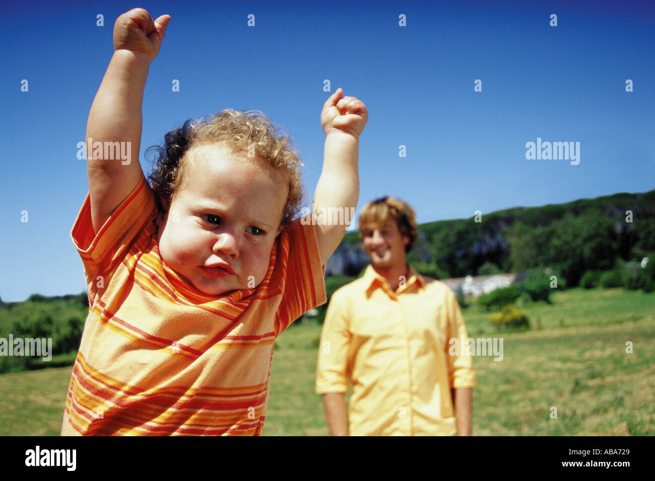 Toddler with arms in the air Stock Photo