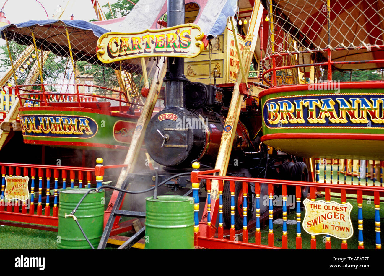 Yorky, a 1901 Savage steam engine powering and driving two Steam Yachts fairground rides, Carters Steam fair, Chiswick, London Stock Photo