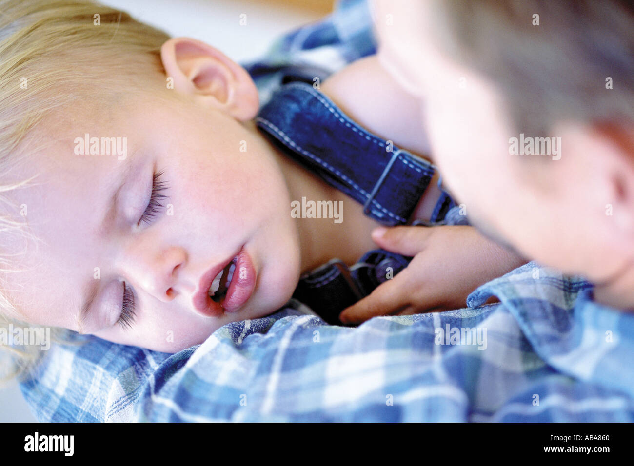 Baby sleeping in dad's arms Stock Photo Alamy