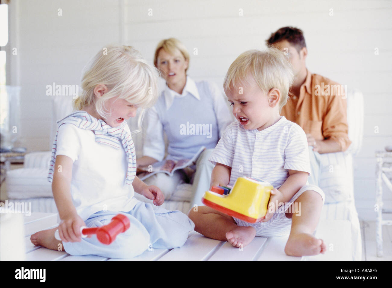 Kids fighting over a toy Stock Photo Alamy