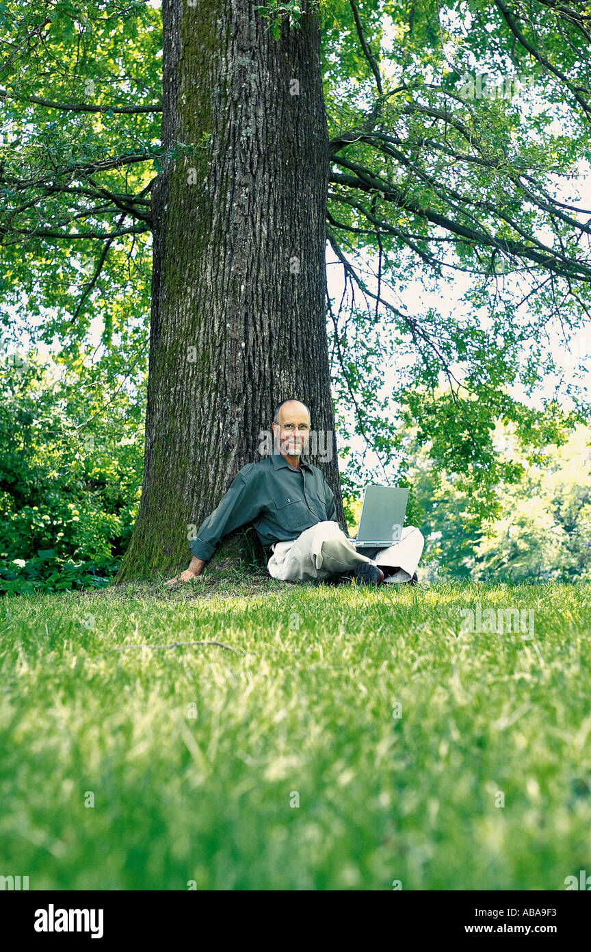 Old man with laptop outdoors hi-res stock photography and images - Alamy