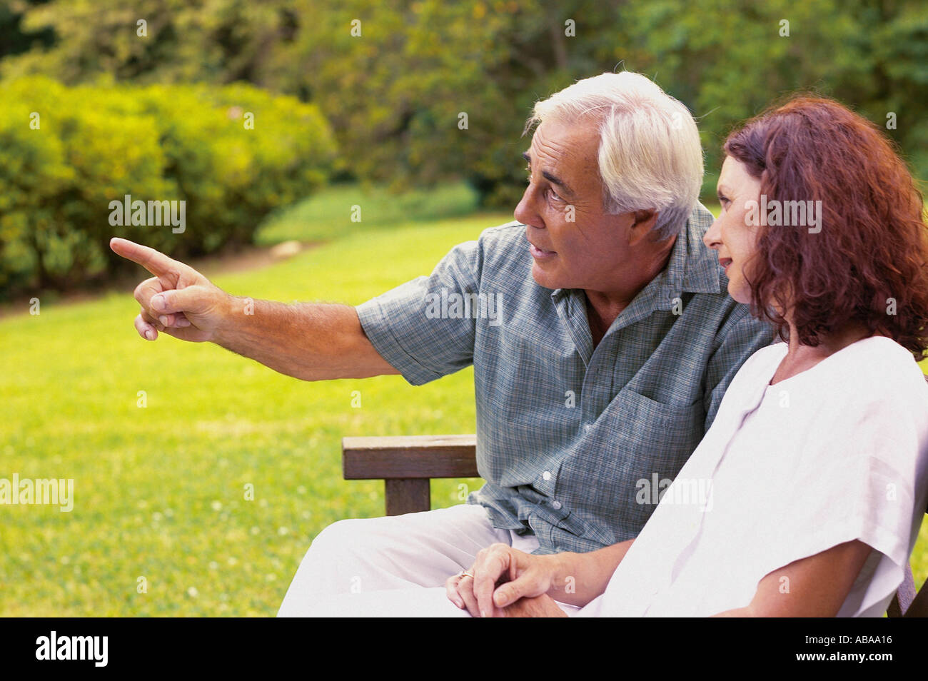 Couple on park bench Stock Photo - Alamy
