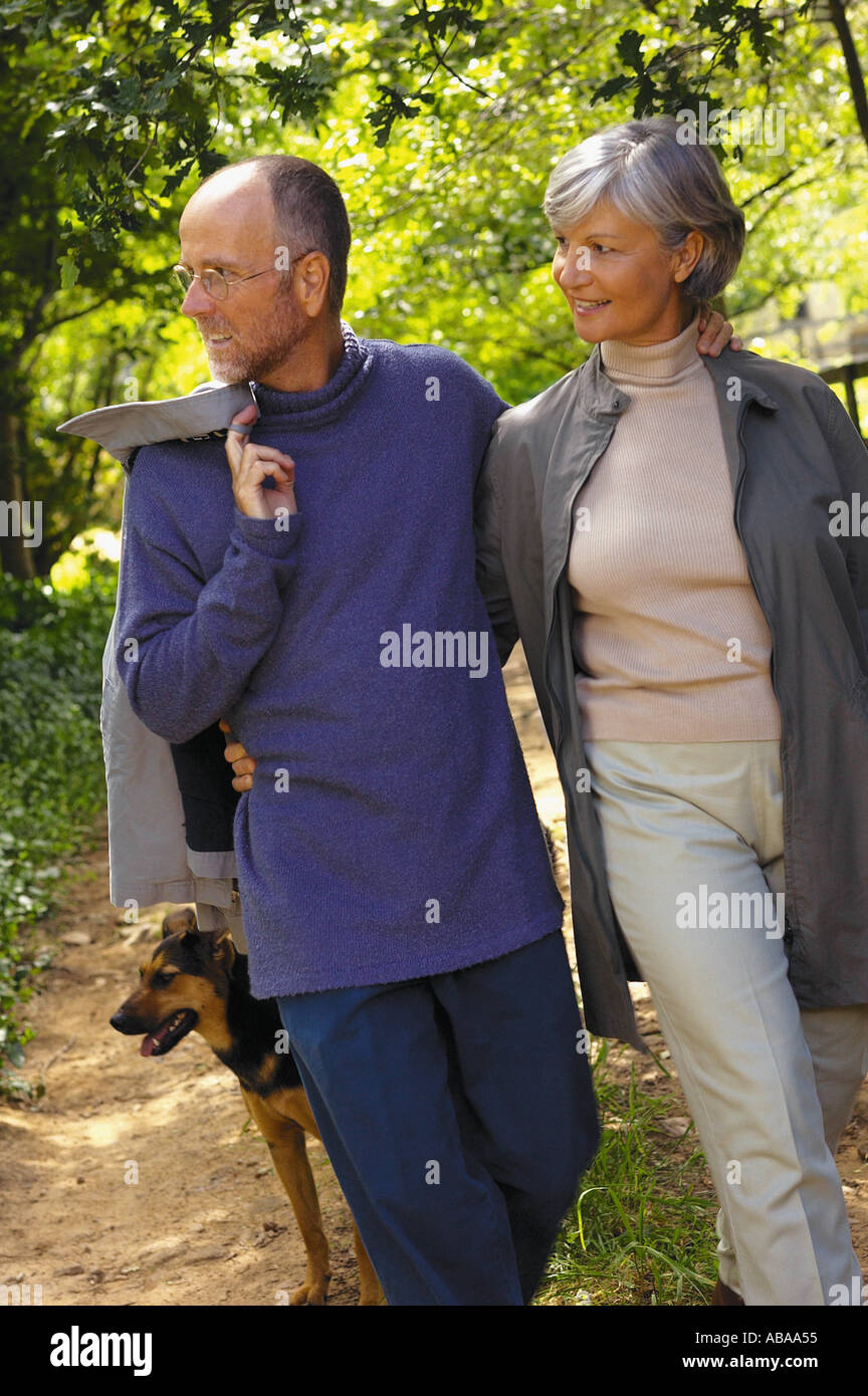 Senior couple walking dog park old man woman hi-res stock photography ...