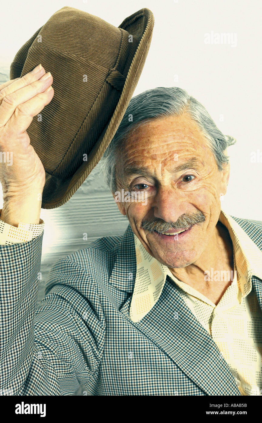 Old man taking hat off Stock Photo
