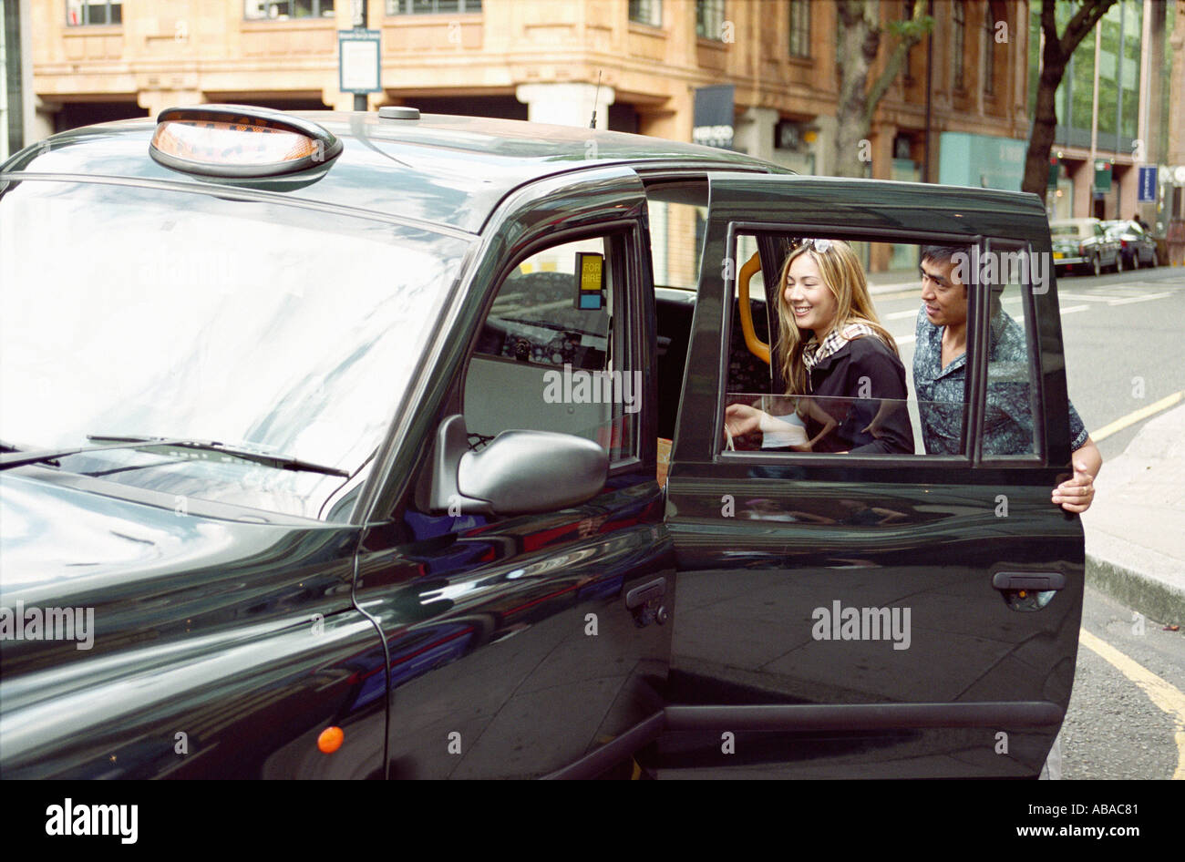 Couple taking taxi Stock Photo Alamy