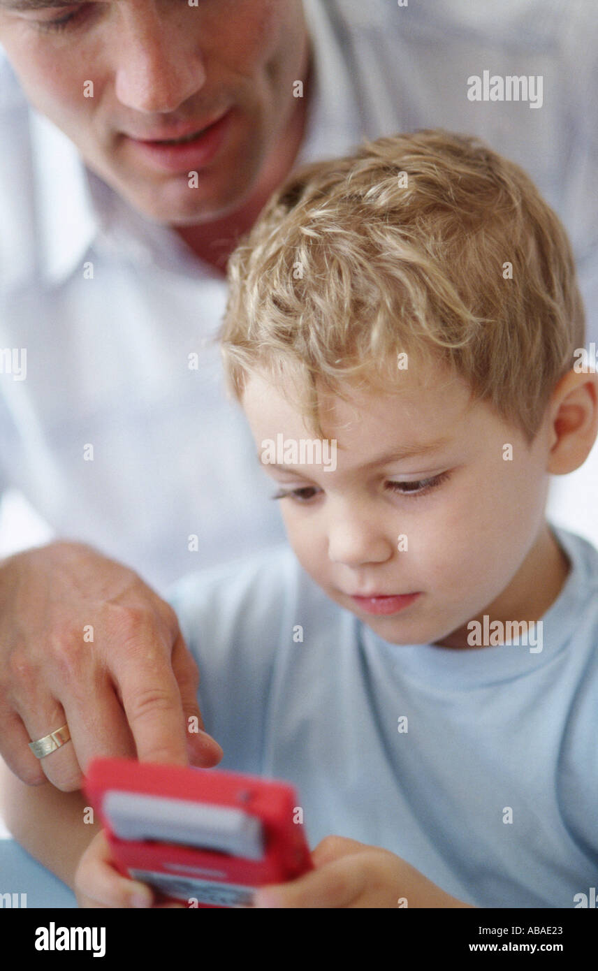 Father and son playing a video game Stock Photo