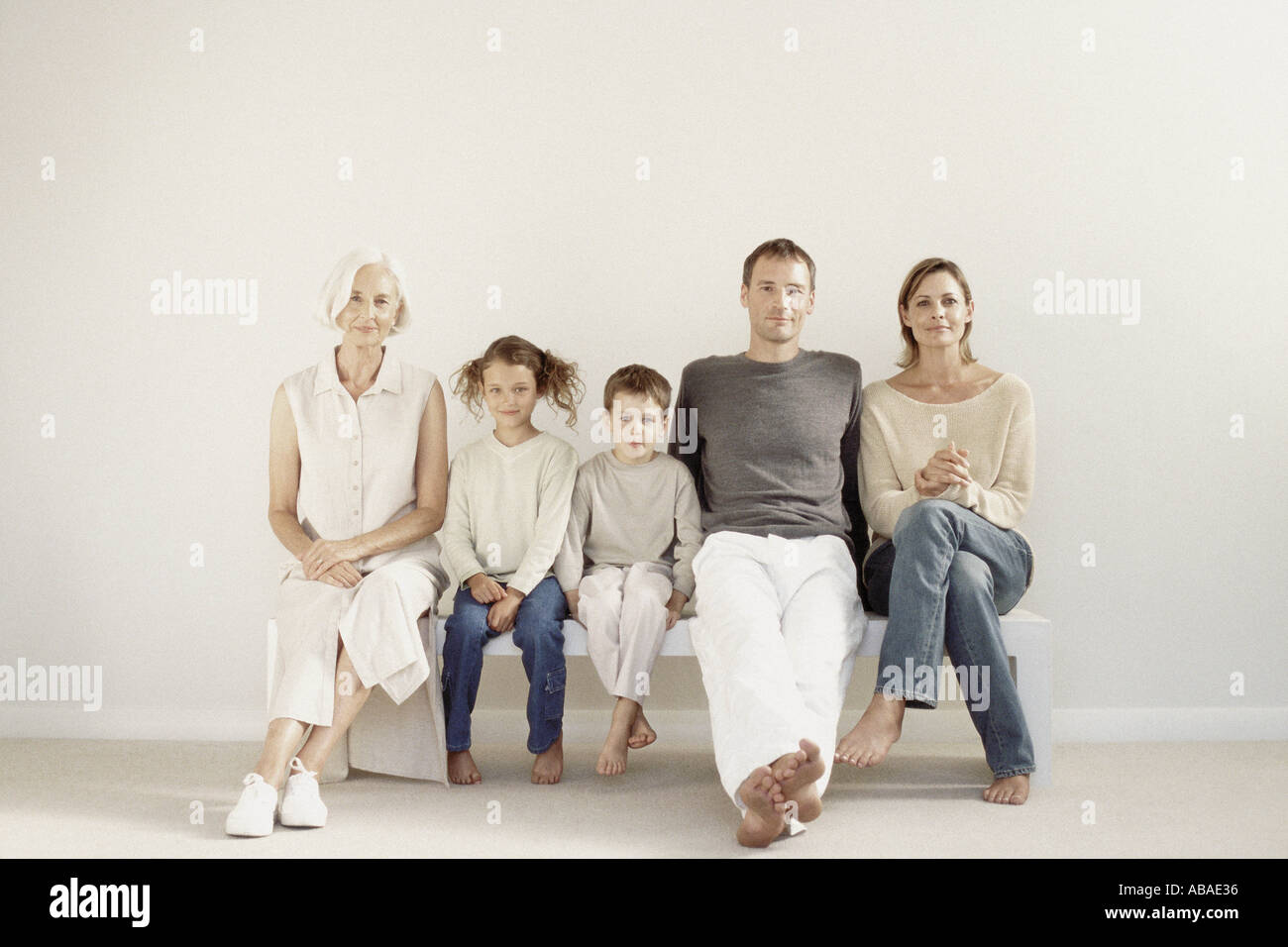 family-sitting-in-a-row-stock-photo-alamy