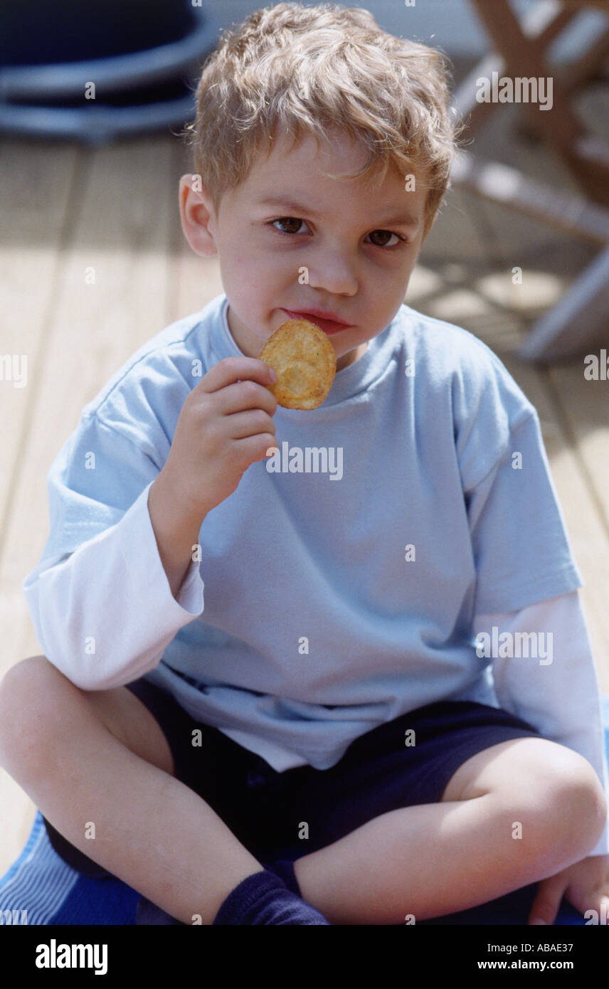 Boy eating biscuit Stock Photo Alamy