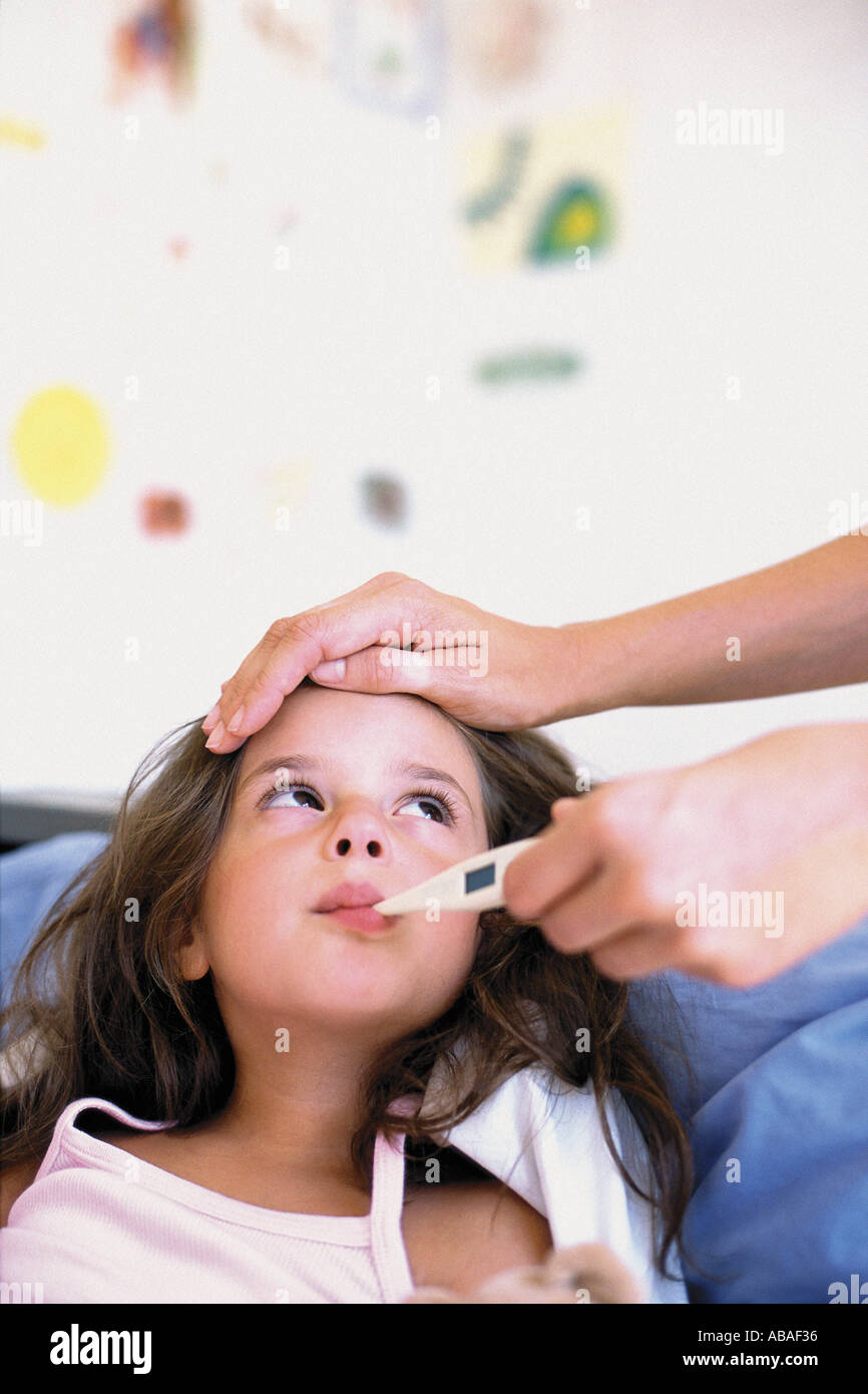 Girl with thermometer in mouth Stock Photo Alamy