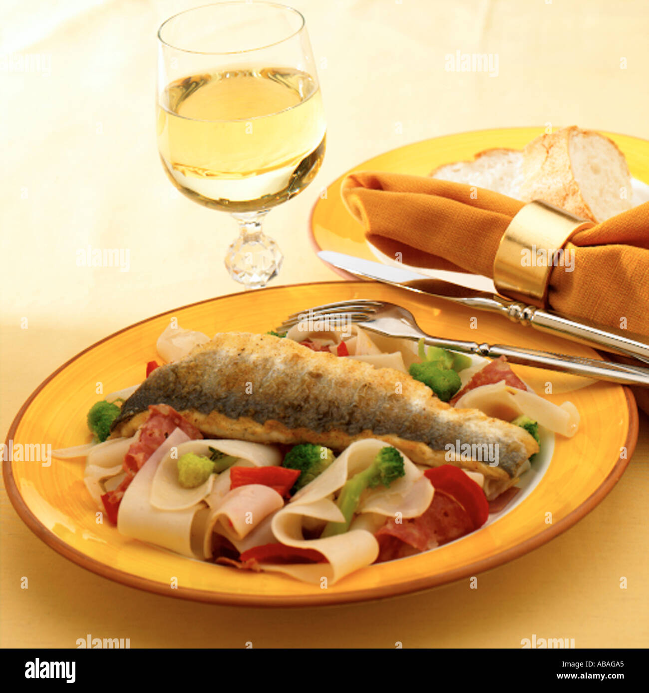 Sea bass fillet with stir fried rice noodles salami and vegetables Keywords fish healthy single