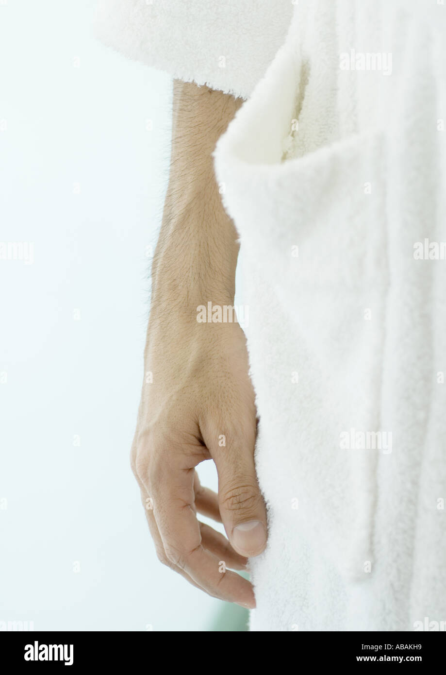 Close-up of man's hand next to bathrobe Stock Photo