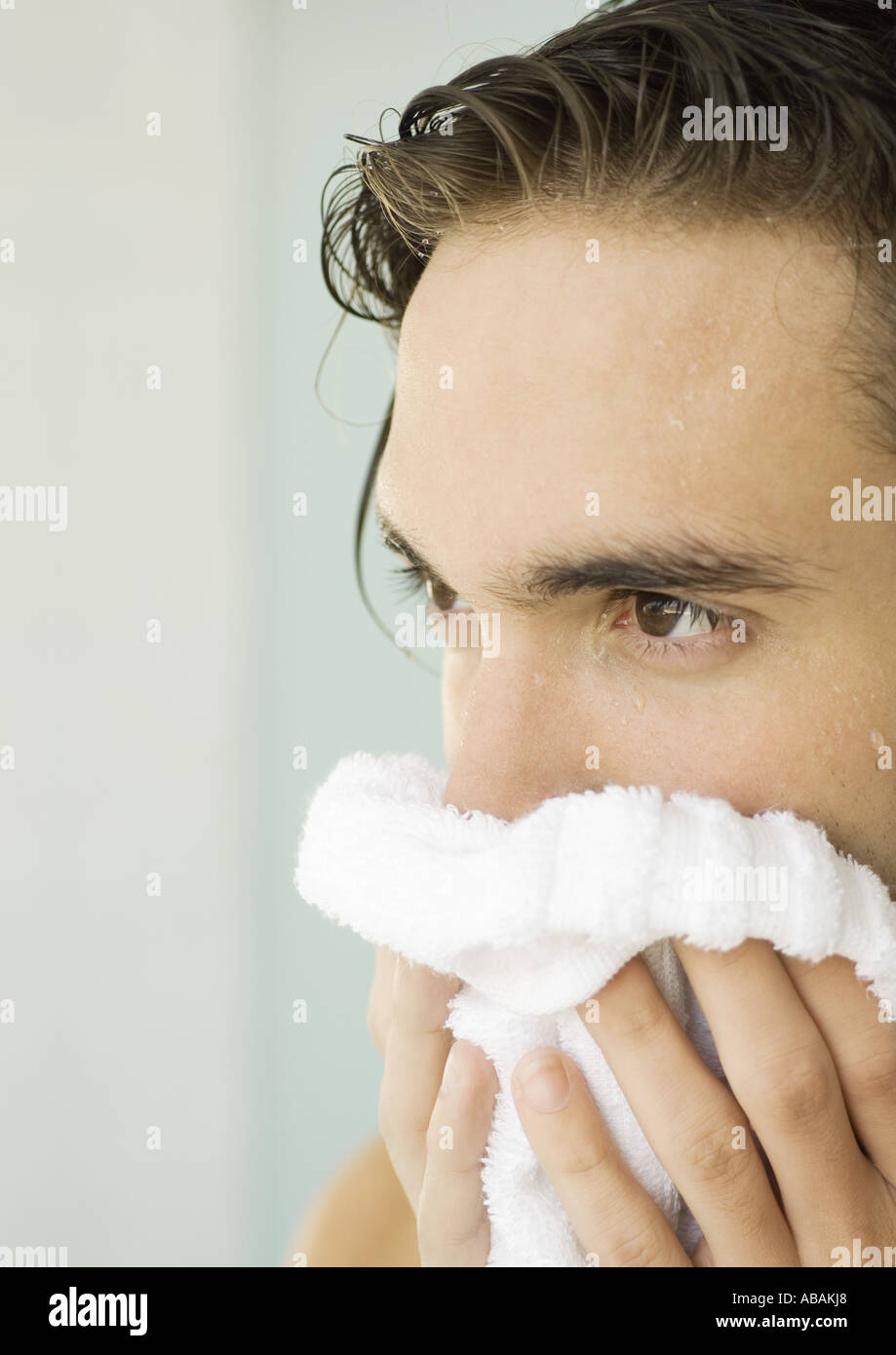 Man drying face with towel Stock Photo Alamy