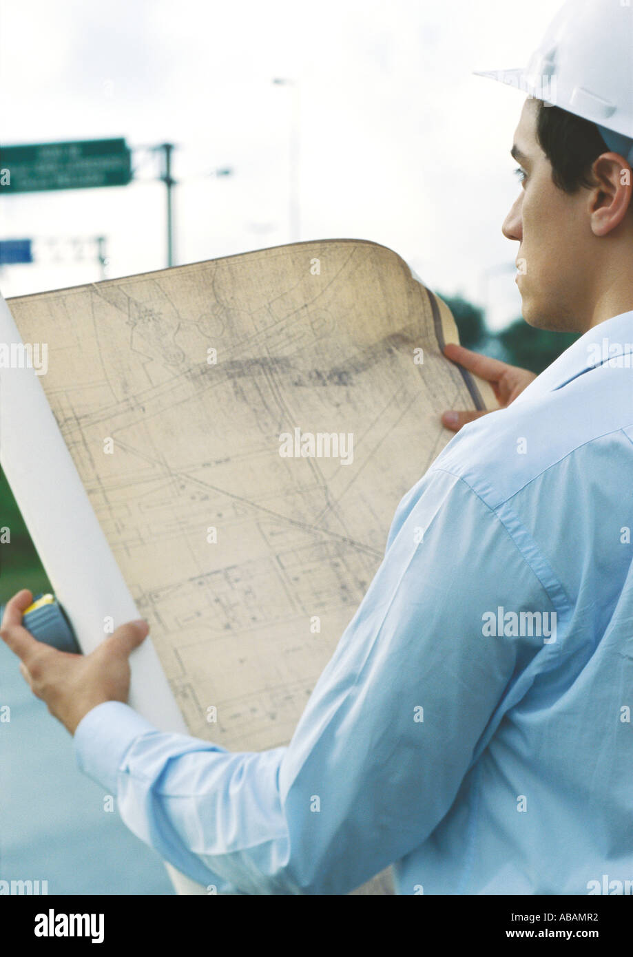 Architect holding up blueprints Stock Photo Alamy