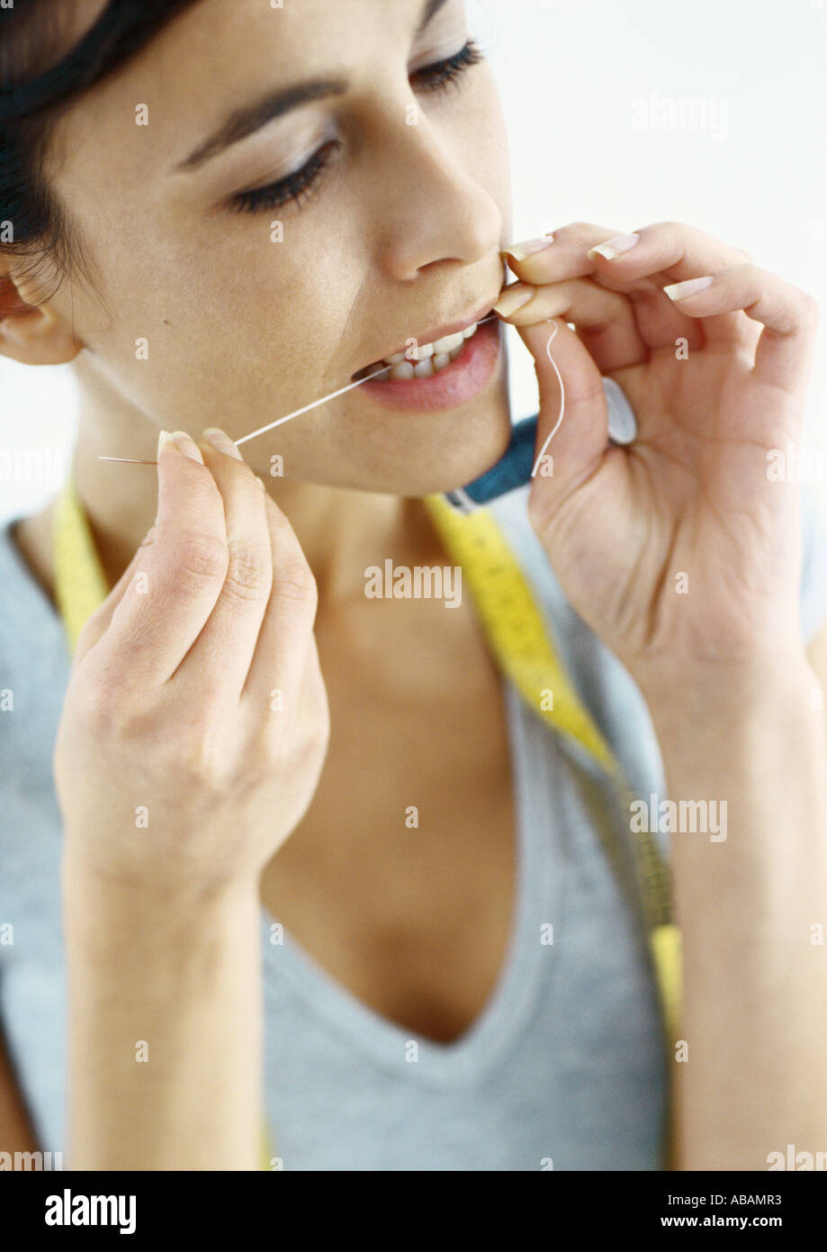 Threading Using Mouth Woman holding measuring tape mouth hi-res stock photography and images ...