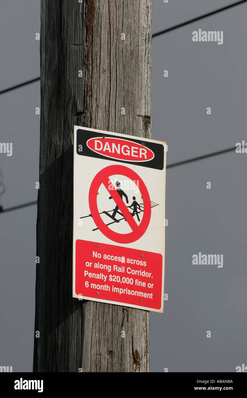 A sign warns of the danger of crossing railway lines Stock Photo