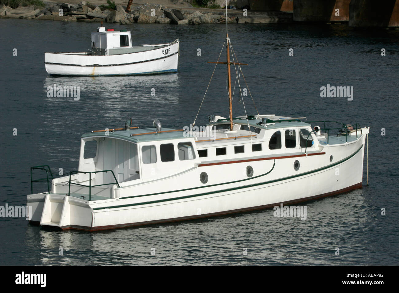 Two wooden boats sit at anchorage in Paramatta harbour New Zealand Stock Photo