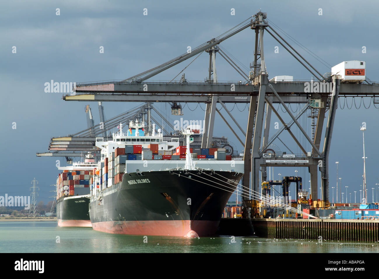 Southampton Container Terminal southern England. SCT straddle carrier unloading container ships. ABP Stock Photo