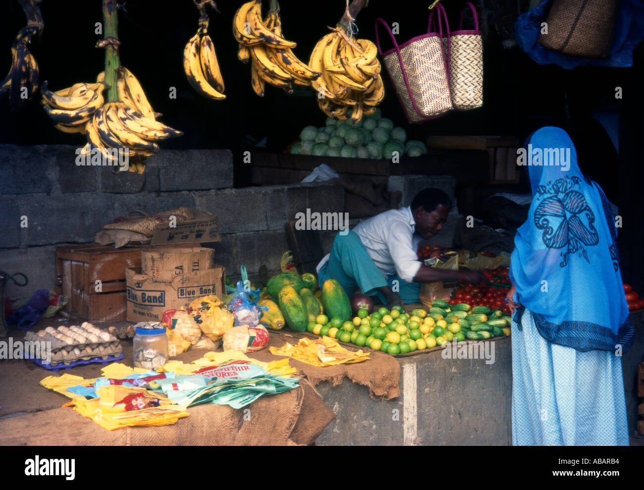 Zanzibar A Zanzibari woman buying from a vegetable stall in the central market in Stone Town Stock Photo
