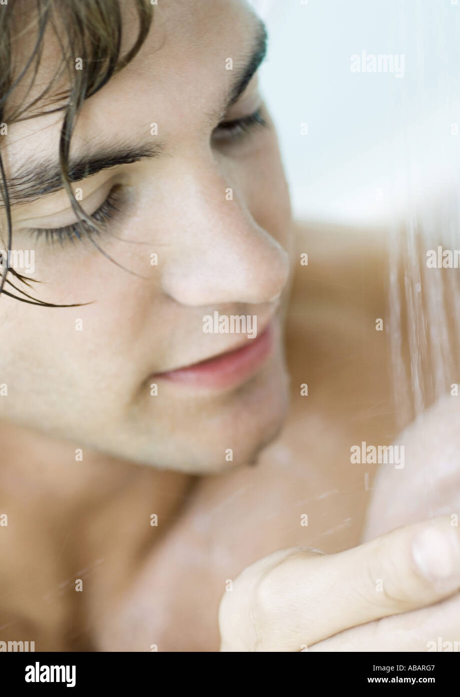 Man in shower, close-up Stock Photo